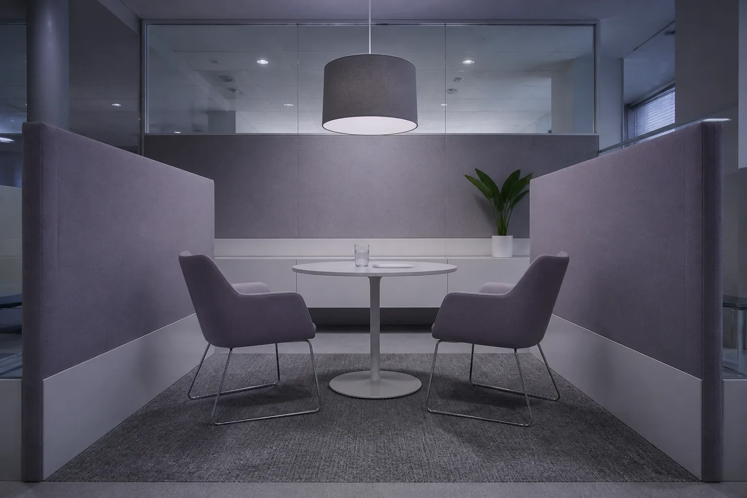 An empty client consultation booth in an insurance branch with two chairs across a round table