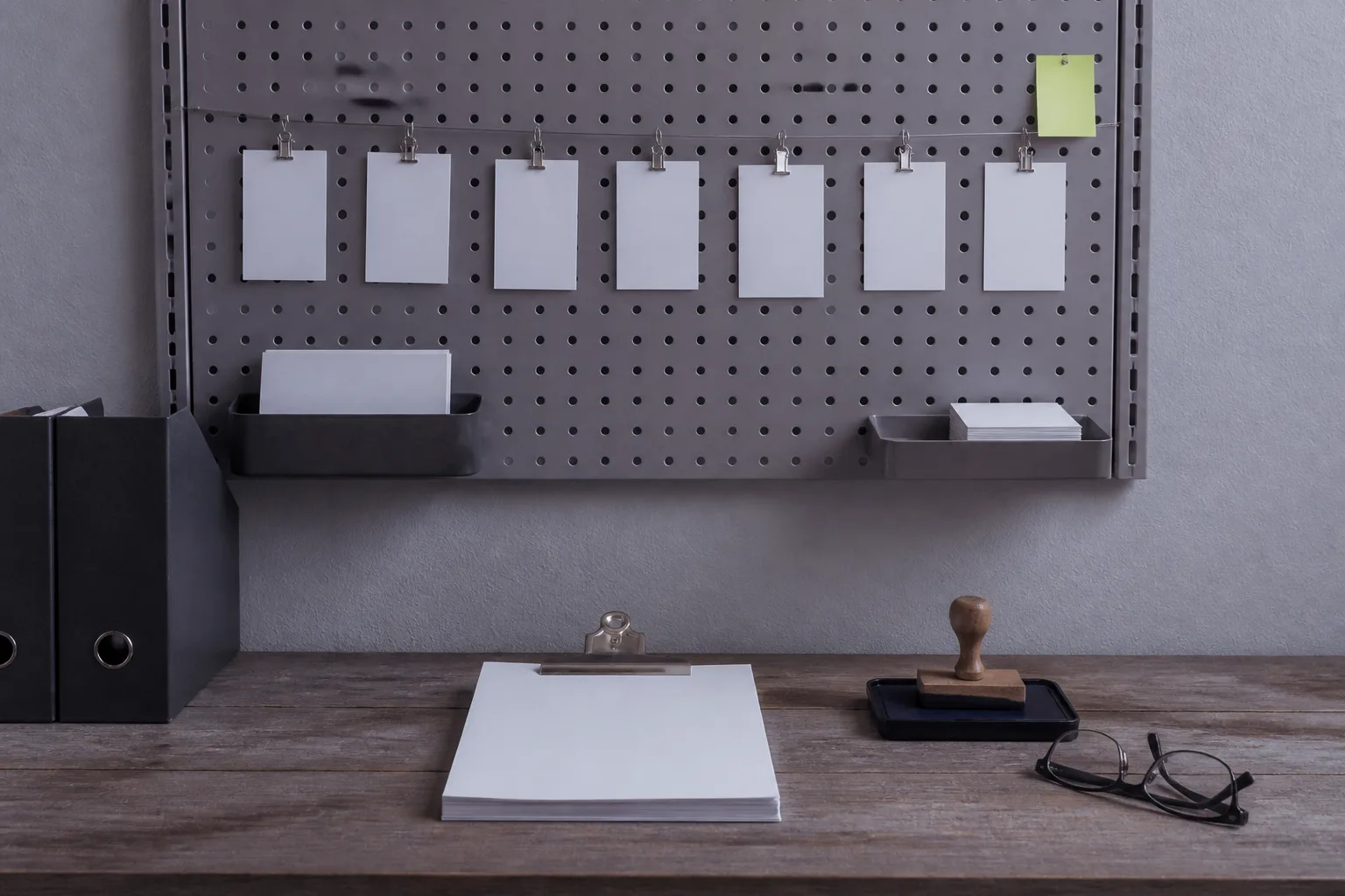 A standards wall for a course business: blank review cards, a checklist and an approval stamp before anything goes live
